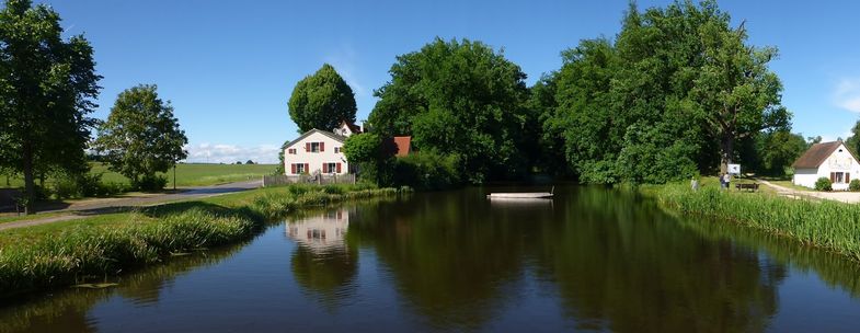 Zentraler Bereich des Karlsgrabens in der Ortschaft Graben. Im Hintergrund sind die bewaldeten Aushubwälle des Kanals zu sehen