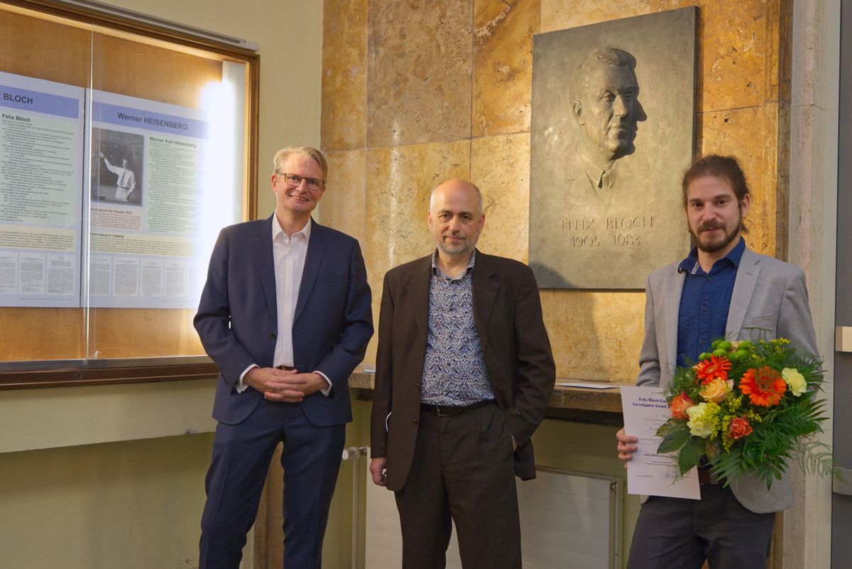 Prof. Dr. Marius Grundmann mit dem Vortragenden Prof. Dr. Dmitry Budker und dem Preisträger des „Felix Bloch Early Investigator Award 2021” Dr. Lukas Botsch (von links nach rechts) im Foyer der Fakultät
