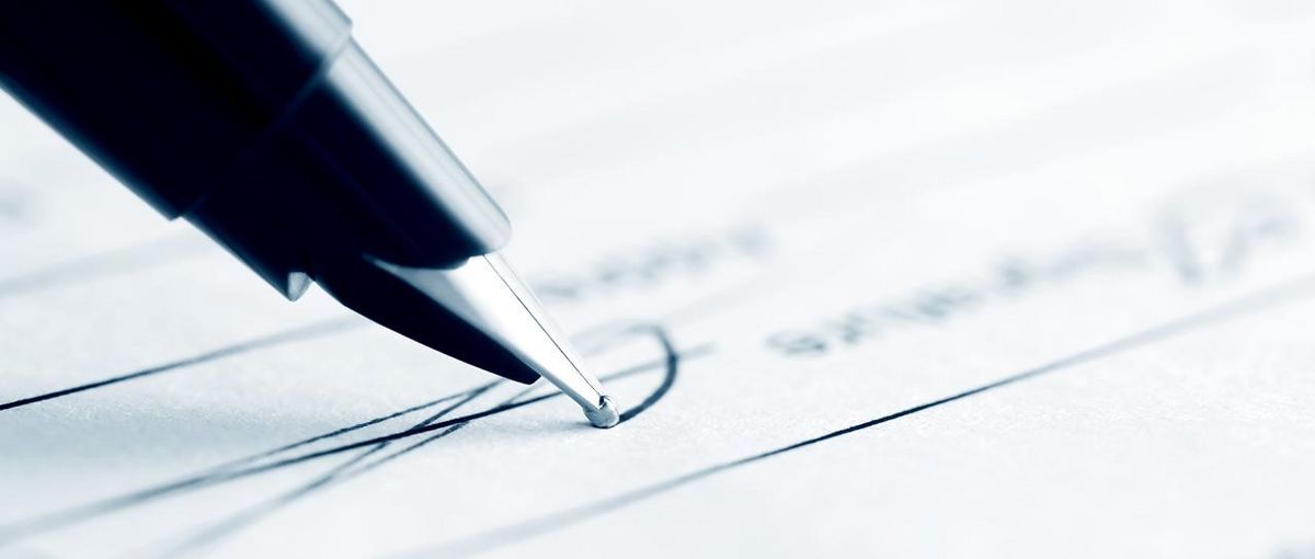 Close-up of a pen while signing a form